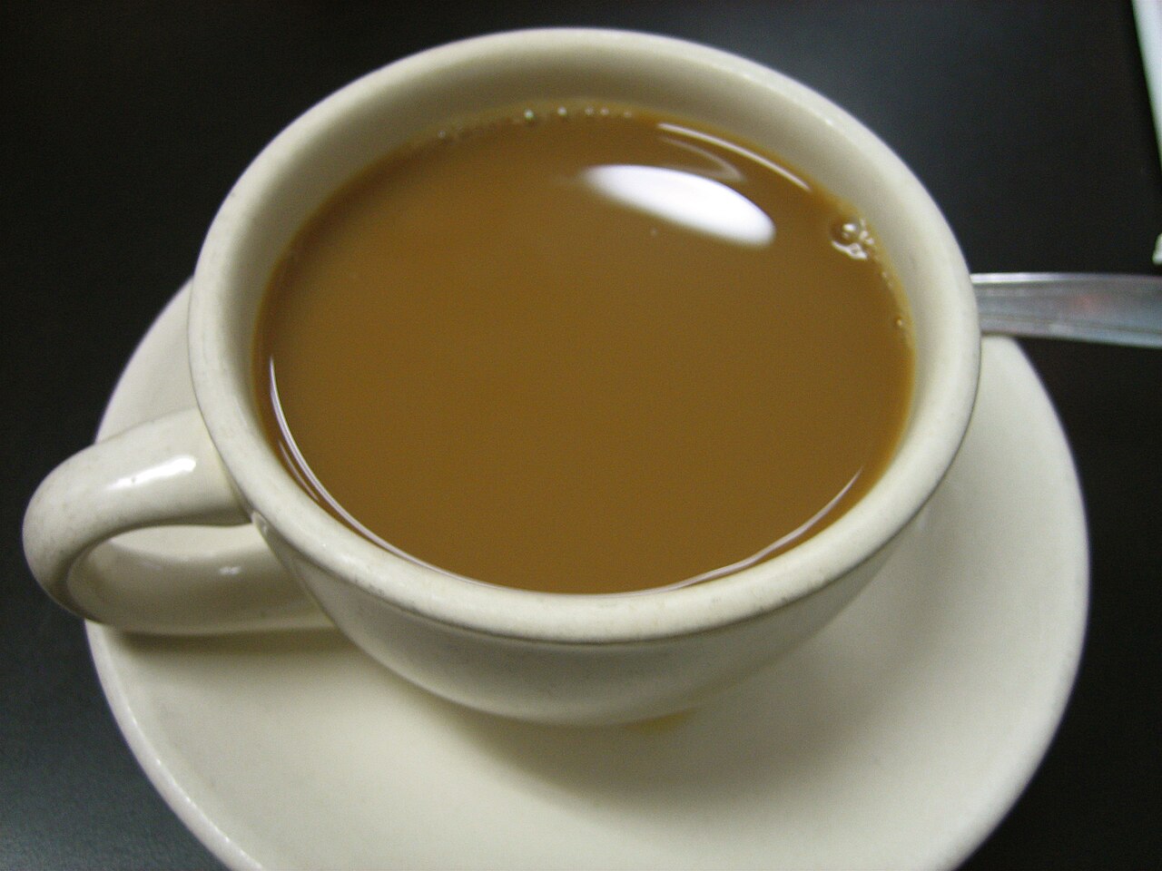 Source-identified café au lait photographed by Tim Boyd. The photograph does not establish whether the coffee was filtered or espresso brewed.