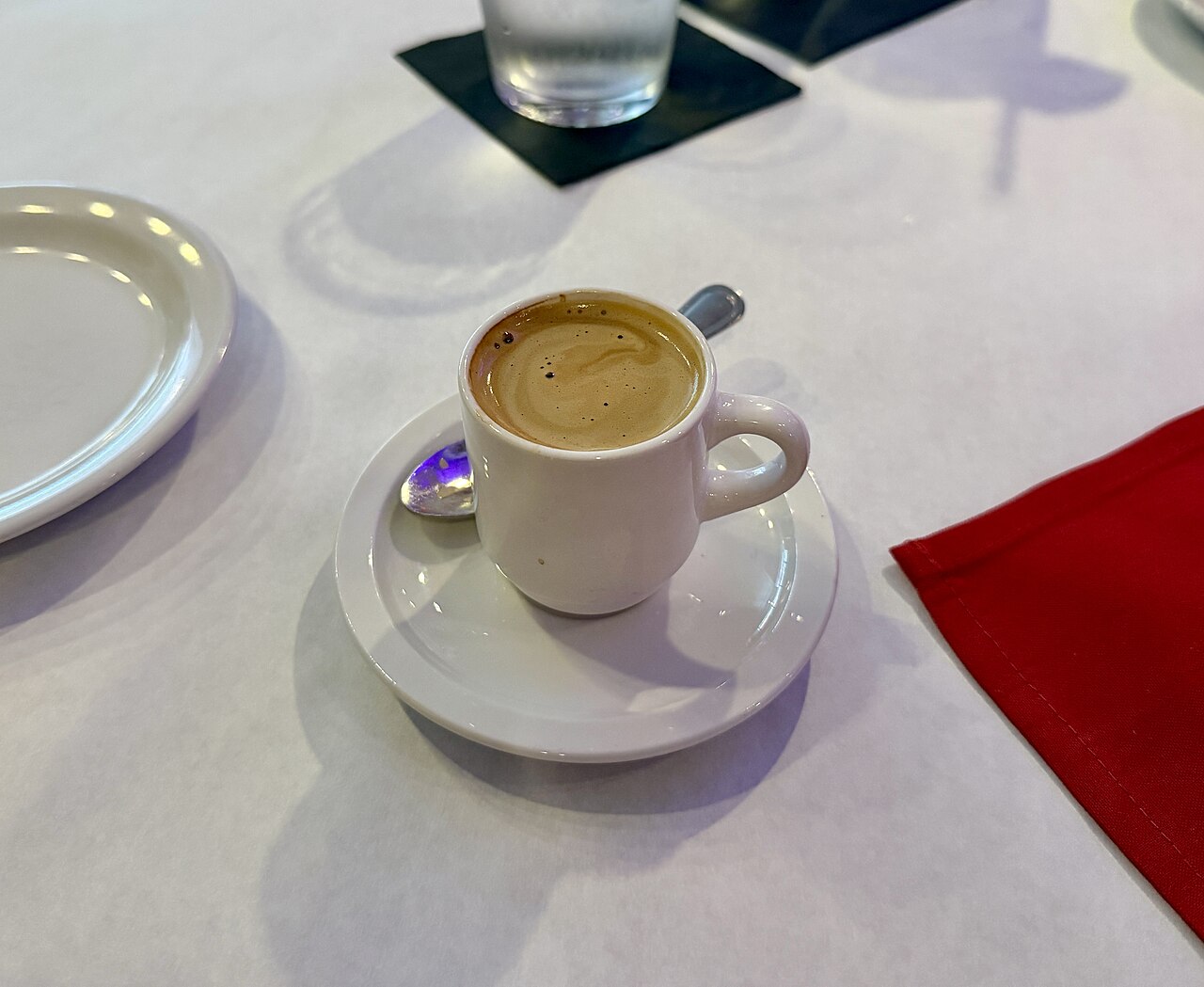 Source-identified café cubano with coffee-and-sugar foam in a small cup. The photograph does not prove a particular moka pot, coffee brand or sugar quantity.