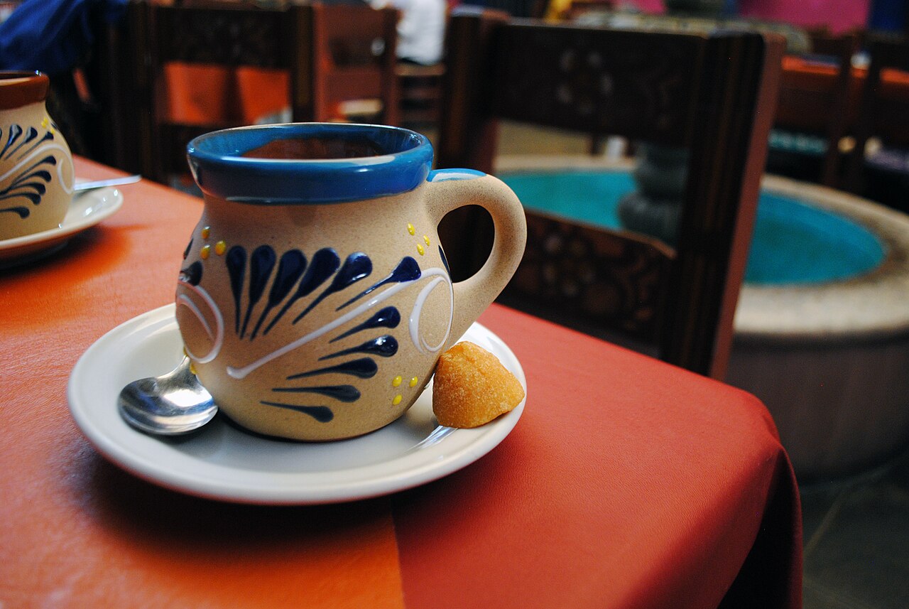 Source-identified traditional café de olla served with panela. The real drink photograph does not prove this cookbook’s chocolate-containing formula.