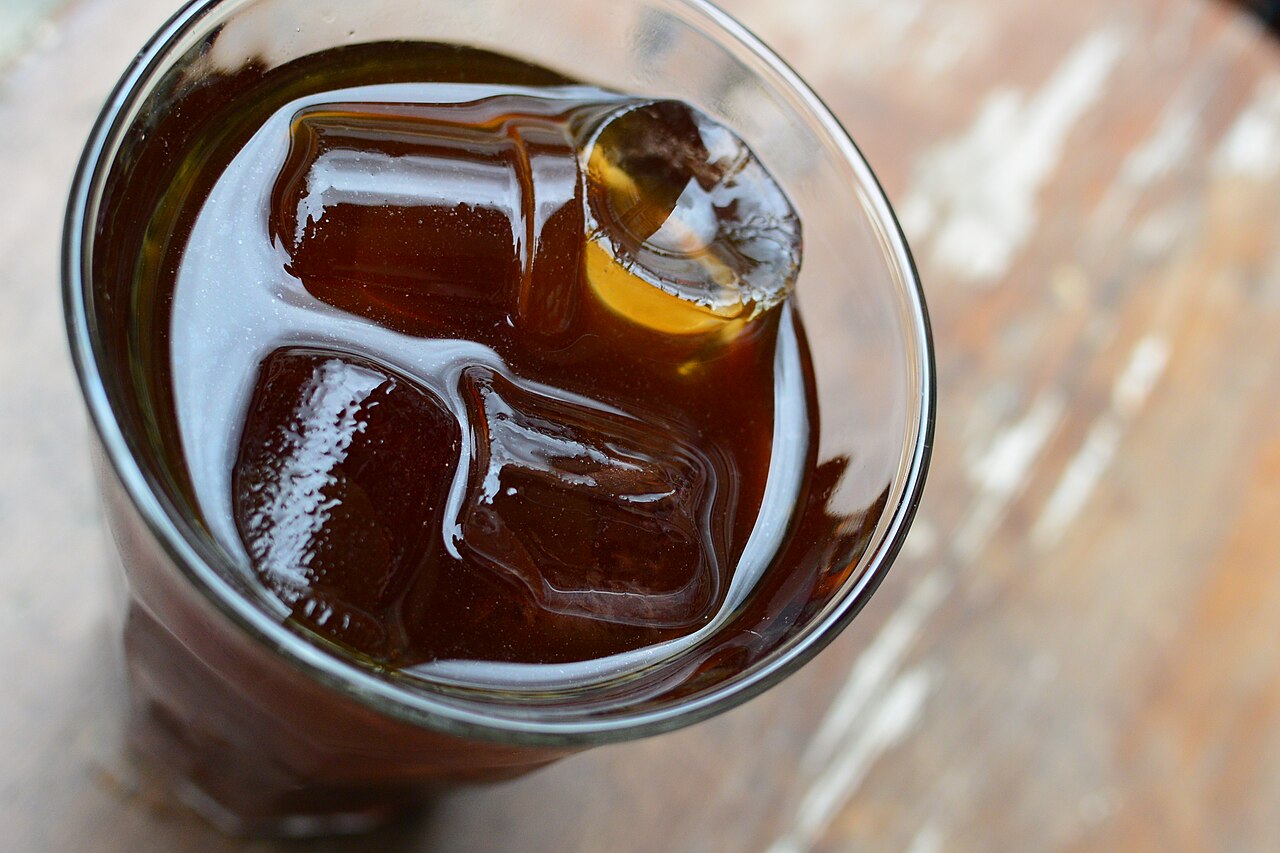 Source-identified iced cold brew in a clear glass. It is a finished-drink photograph; it does not prove a Toddy brewer or a particular dilution ratio was used.