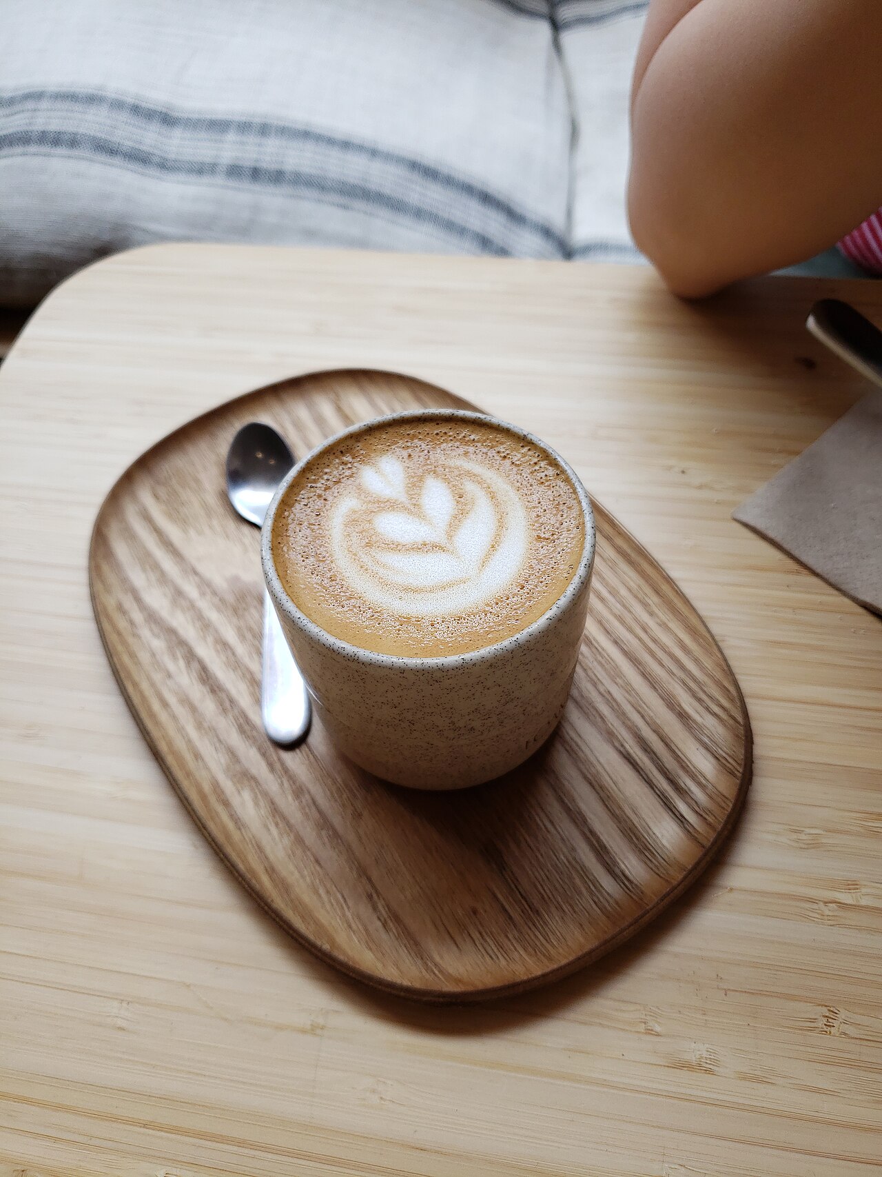 Source-identified cortado at LOAM. The real milk-coffee cup illustrates a café serving, not the exact manufacturer recipe.
