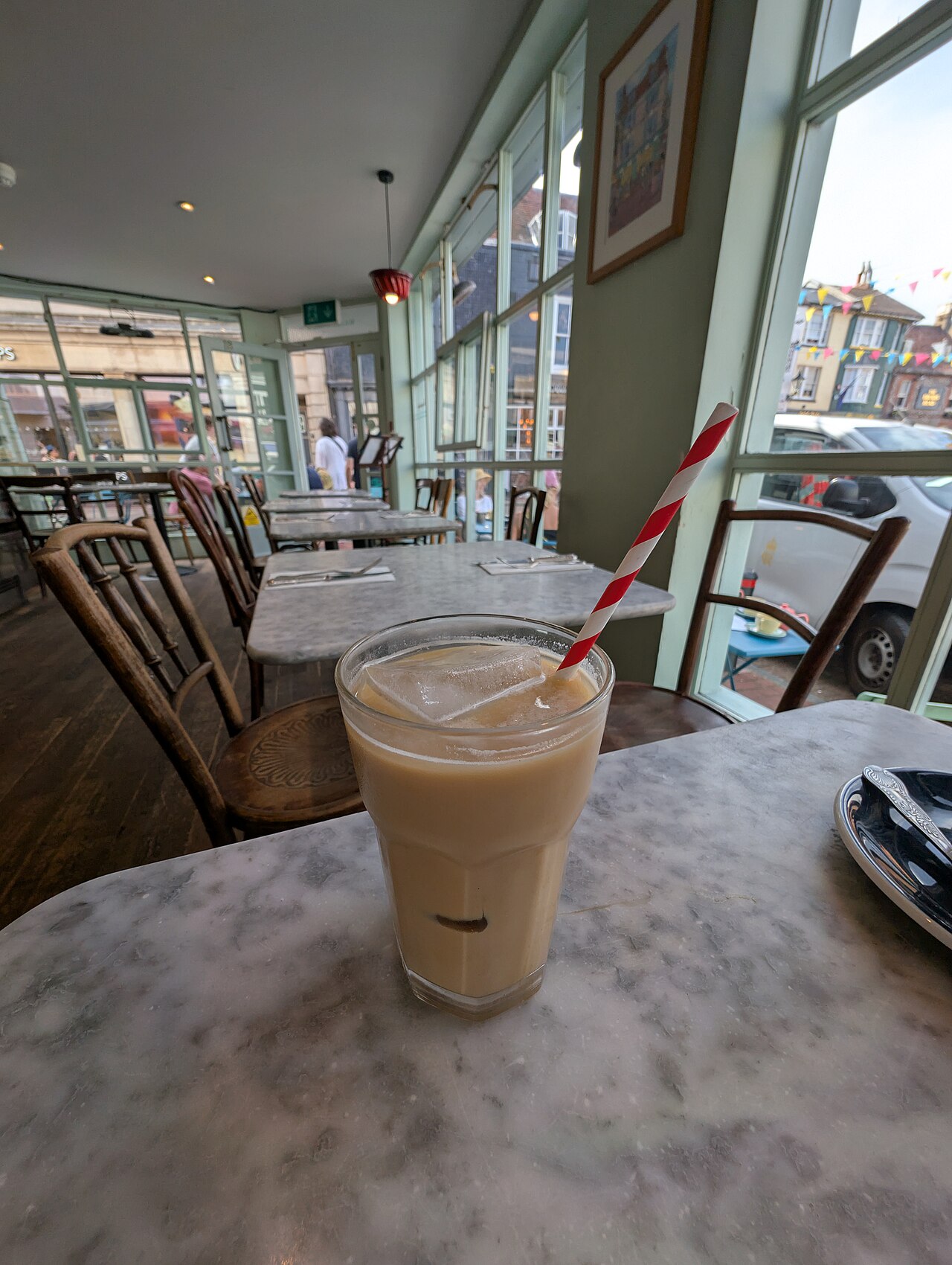 Source-identified iced latte photographed at Sugardough. It illustrates a finished iced milk coffee, not the exact capsule or milk quantity in the named recipe.