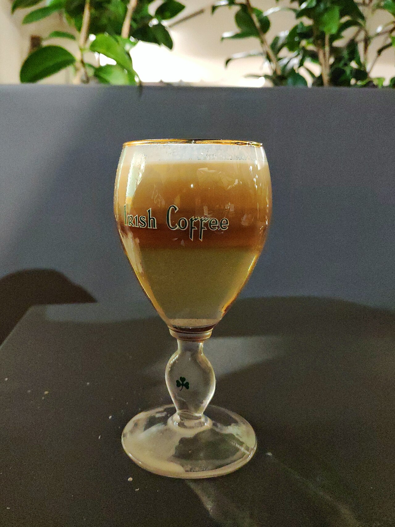 Source-identified Irish coffee in a labelled glass. Visible layers illustrate a presentation, not proof of the Buena Vista whiskey or ingredient proportions.