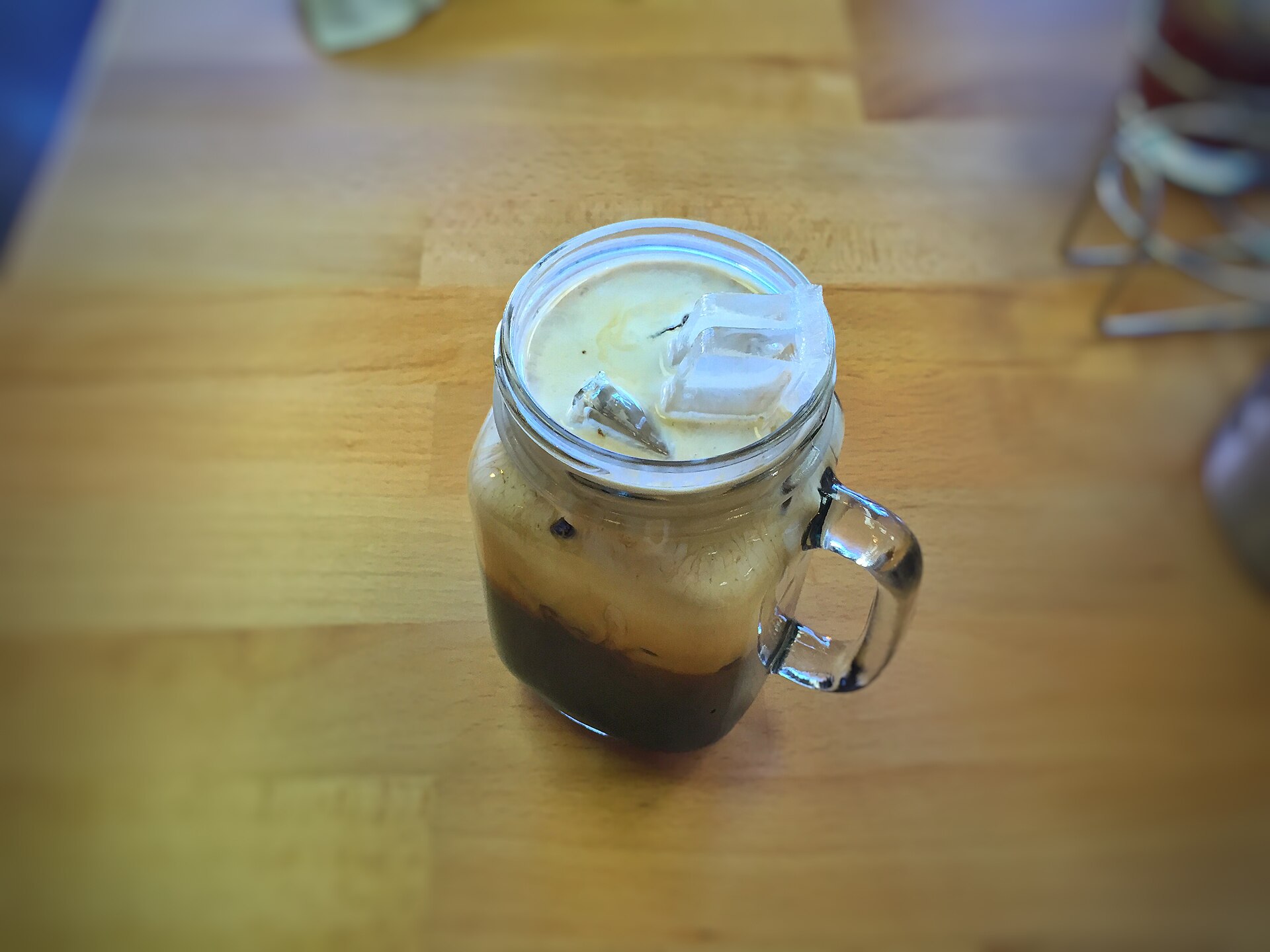 Thai iced coffee photographed by T.Tseng at Luv2eat Thai Bistro, Hollywood, California. This restaurant version is separate from the named home preparation; the photograph does not establish quantities.