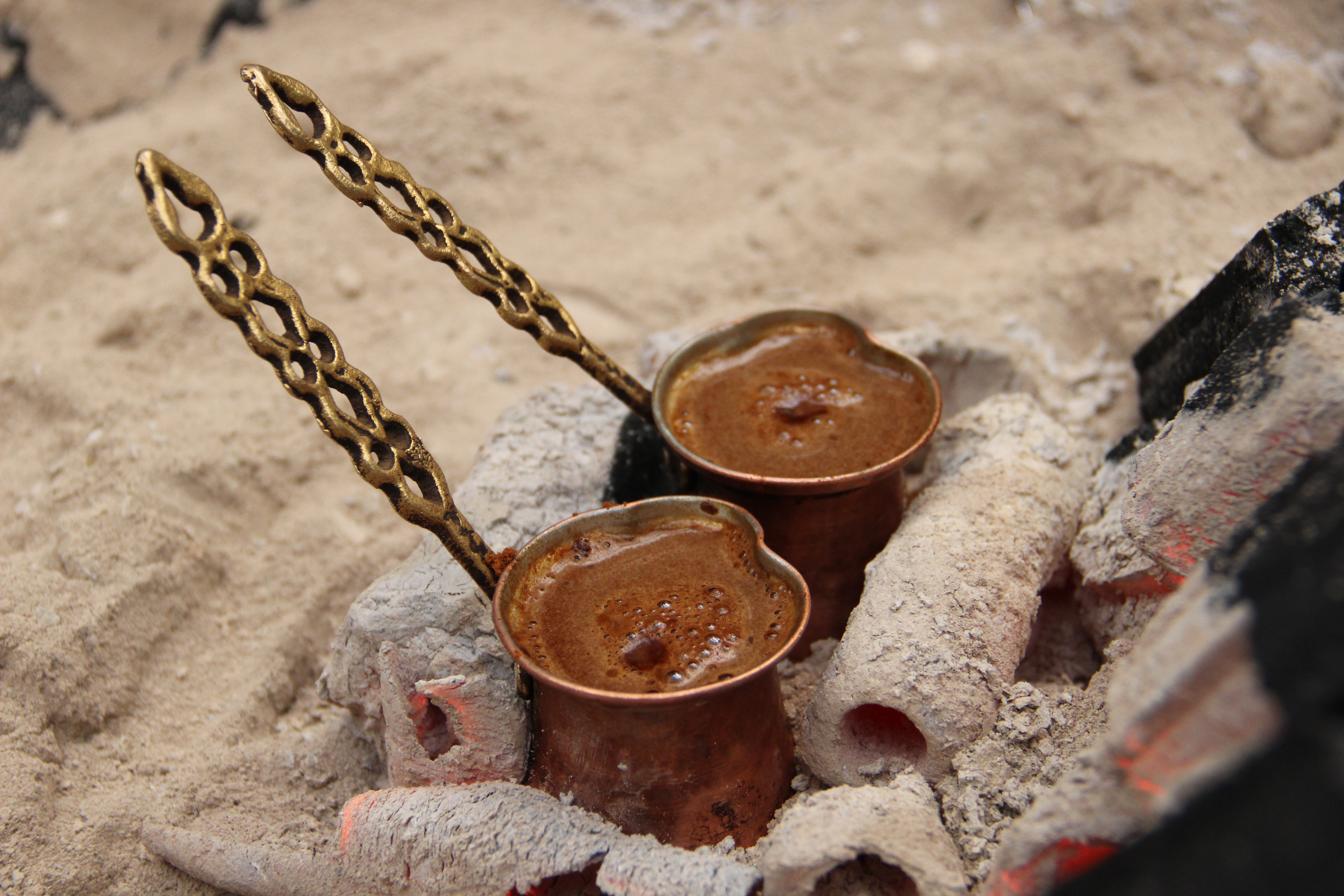 Coffee vessels heated in sand during preparation
